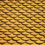 Close-up of a golden scaled roof pattern, ideal for design backgrounds or wallpapers.